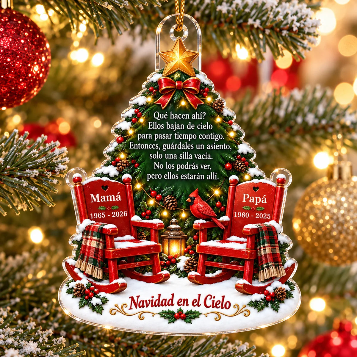 Close-up of a Spanish memorial acrylic Christmas ornament featuring red rocking chairs labeled Mamá and Papá with Spanish