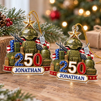 Two custom military ornaments displayed together on a wooden surface with holiday decorations.