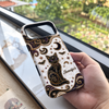 Customer in Austin, Texas wearing Mystical Black Cat Phone Case Celestial Gothic Witchy Design with Gold Stars Moons Bats for Cat Love