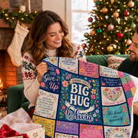 A smiling couple holds a custom floral throw blanket with positive quotes and the name Olivia, in a festive holiday room.