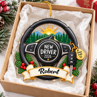 Personalized new driver ornament displayed inside an open gift box lined with white tissue paper.