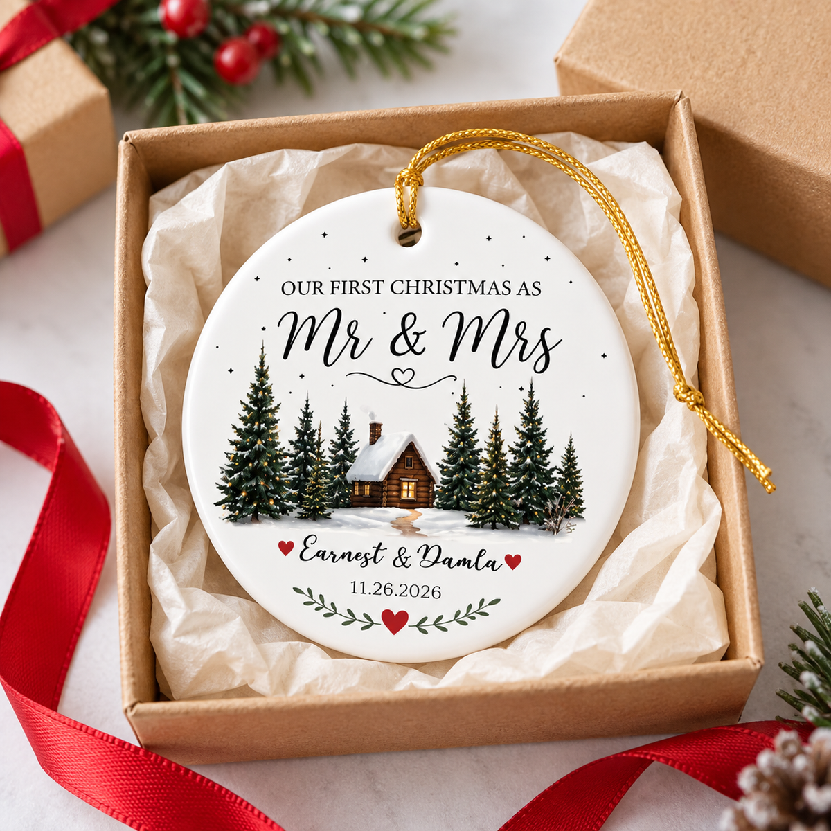 Personalized Mr & Mrs ornament nestled inside an open gift box with tissue paper and red ribbon.
