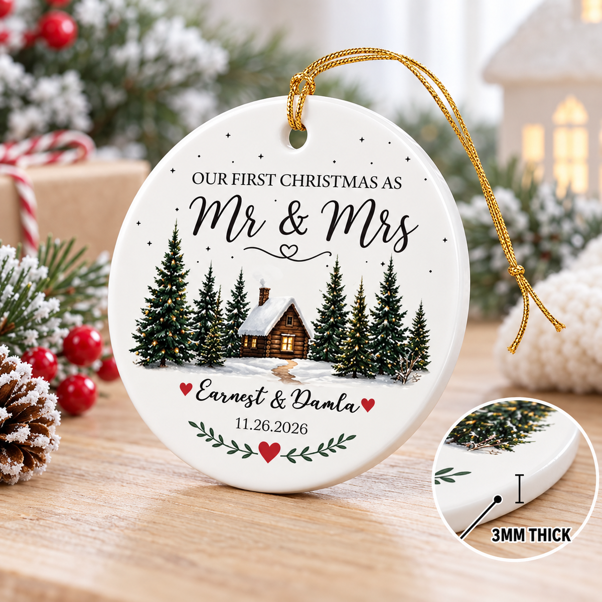 Mr & Mrs ceramic ornament featured next to a glowing holiday decoration and pine branches.