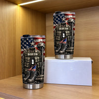 Two patriotic military veteran tumblers of different sizes displayed on a wooden shelf in front of a white box.