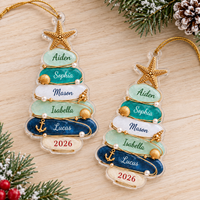 Two personalized Beach Theme Family Christmas ornaments displayed side by side on a wooden tabletop.
