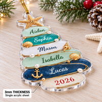 Close-up of a nautical holiday gift acrylic ornament resting on a wooden surface with pinecones.