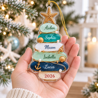 Person holding a custom sea glass ornament featuring five family names and the year 2026.