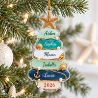 Personalized beach theme family Christmas ornament hanging on a pine tree branch with fairy lights.