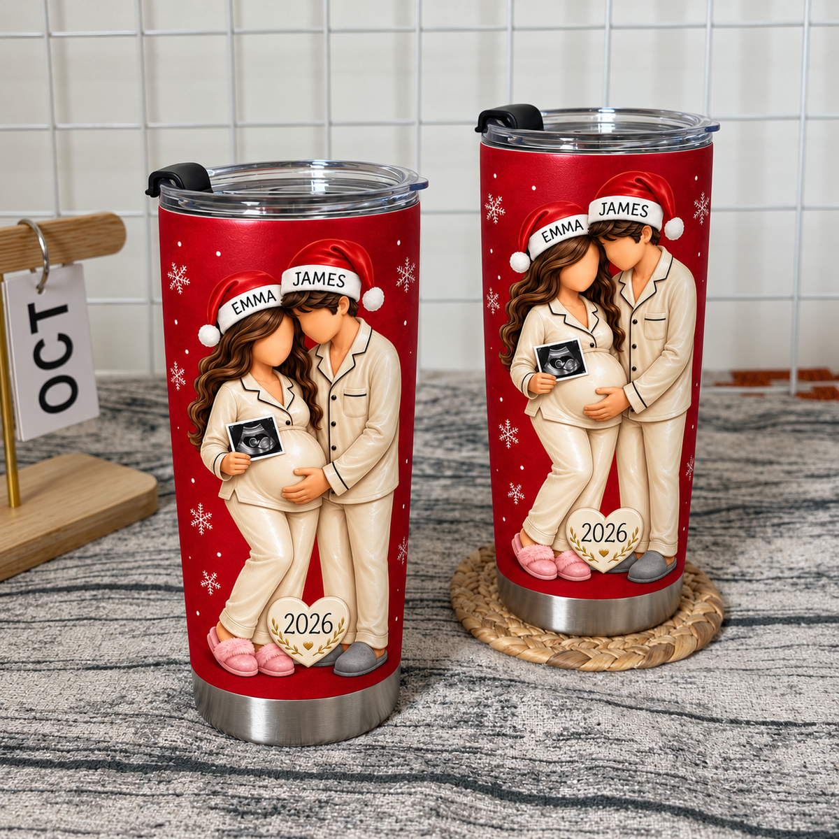 Two red ultrasound tumblers with matching cream pajamas on a rustic wooden table with a calendar.