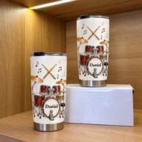 Two personalized drummer gift tumblers with drum set design and custom name Daniel on display shelf with white box.