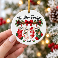 Hand holding a custom family name gift ceramic ornament featuring Dad, Mom, and kids names.