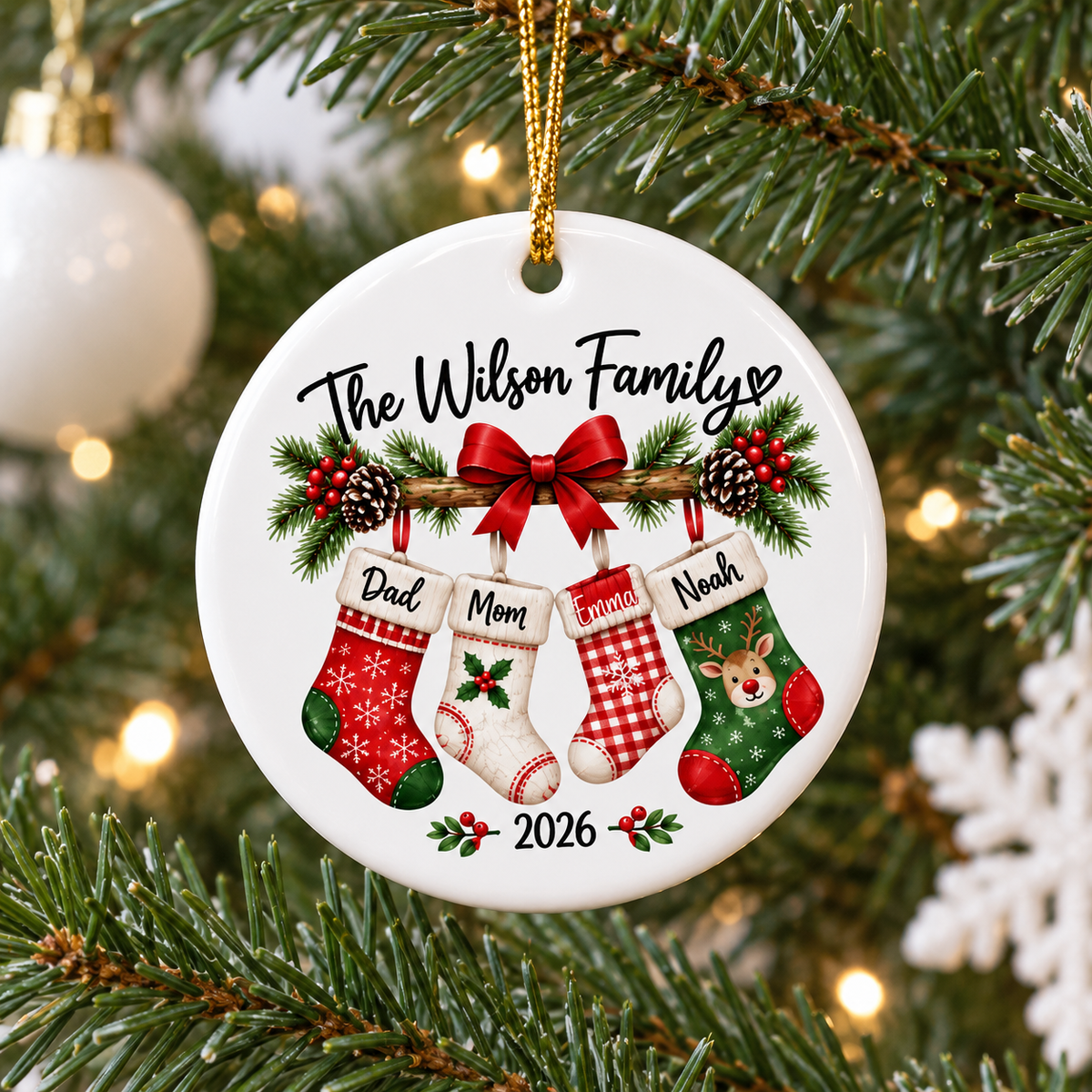 Personalized Family Christmas Ornament hanging on a pine tree with green needles and lights.