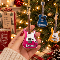 A hand holding a custom pink electric guitar Christmas ornament with the name Emma printed on it.