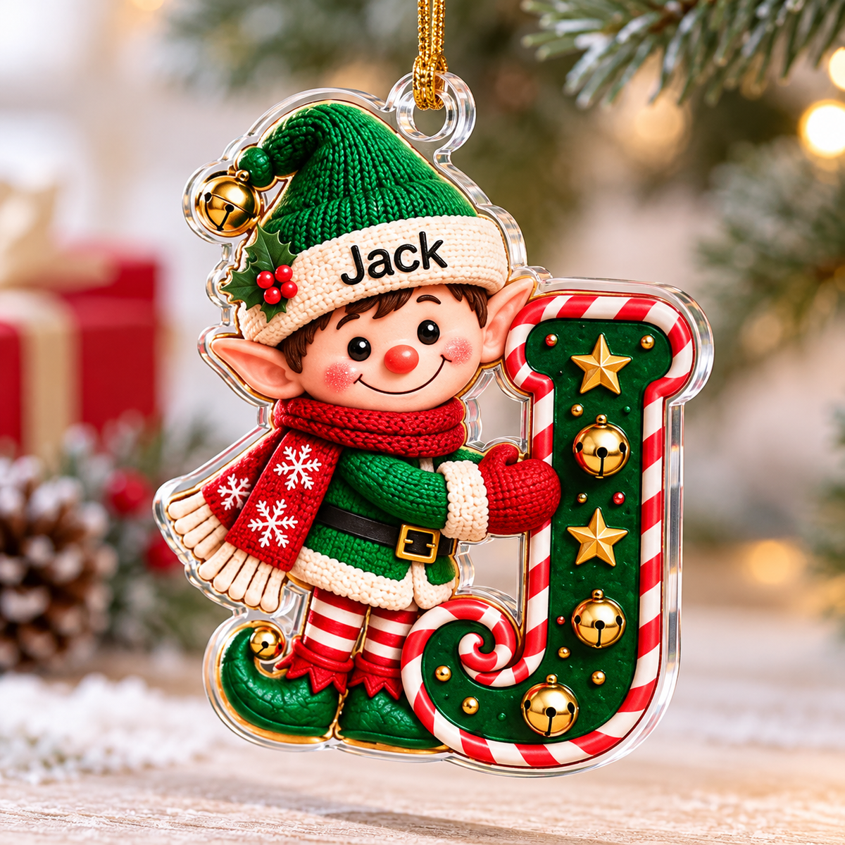 Elf initial letter Christmas ornament with custom name Jack hanging near pine branches.