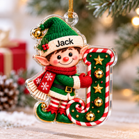 Elf initial letter Christmas ornament with custom name Jack hanging near pine branches.