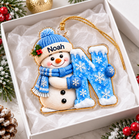 Personalized Snowman Letter Ornament in white gift box with gold cord and pine branch.
