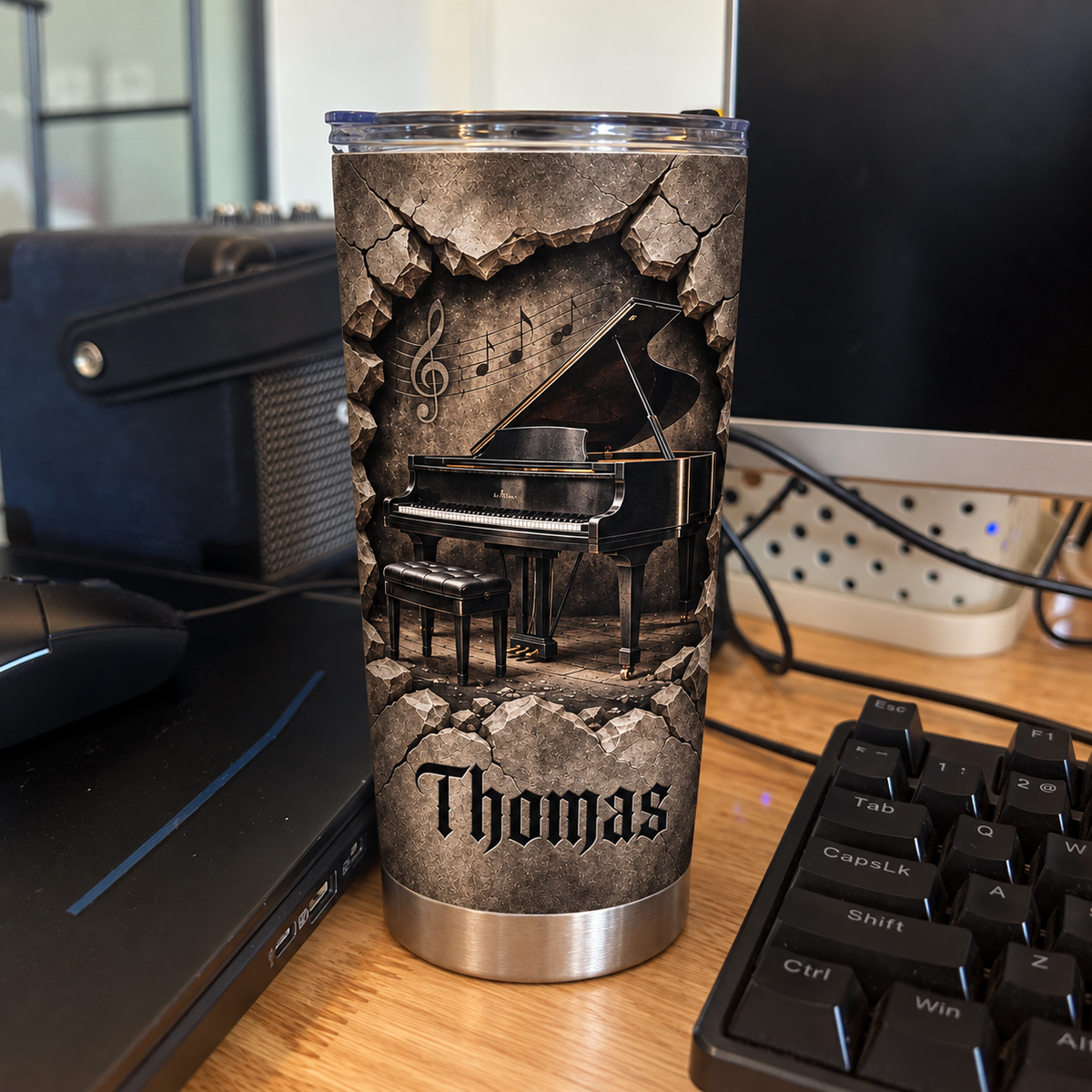 Custom piano tumbler with distressed vintage grunge design on a desk next to keyboard and computer.