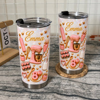 Two stainless steel insulated travel mugs with pink mixer and pastry graphics