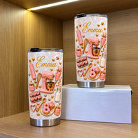 Two custom name tumblers displayed on a wooden shelf with a white gift box