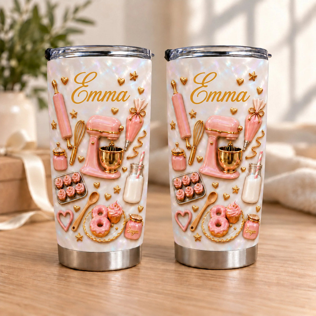 Two custom name tumblers with pink baking graphics on pearlescent white stainless steel