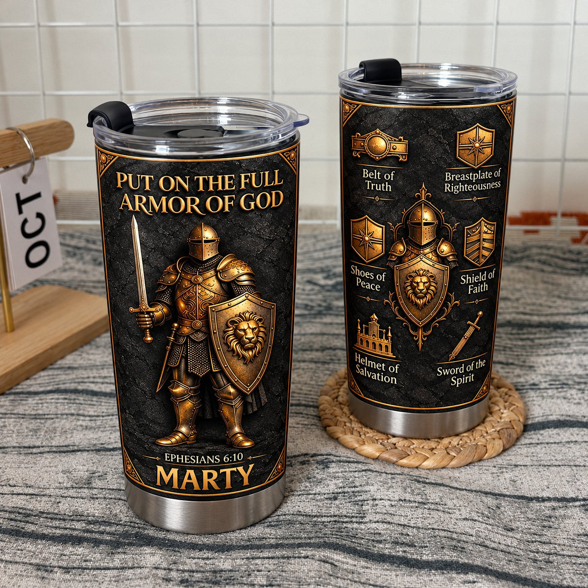 Two Full Armor Of God tumblers on textured surface with calendar blocks and woven coaster
