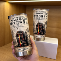 Hand holding a personalized Full Armor Of God tumbler with a kneeling knight graphic and the name Matthew.