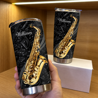 Hand holding a black and gold custom saxophone musician tumbler with the name William printed in white script.