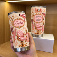 Hand holding personalized hair stylist tumbler with rose gold salon chair graphics and Sophia name label next to box on