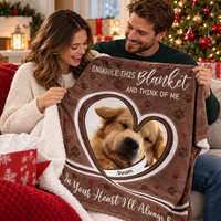 Couple holding a brown fleece pet memorial blanket with a dog photo inside a heart frame and text.