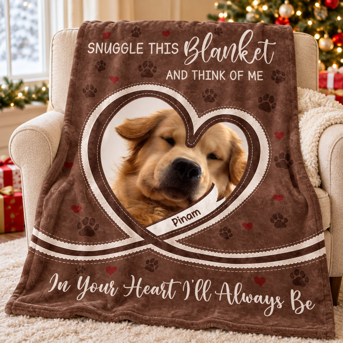 A brown plush fleece throw blanket with a golden retriever photo in a heart frame, resting on a beige armchair.