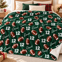 A green football pattern blanket with name Daniel and number 12 spread across a made bed.