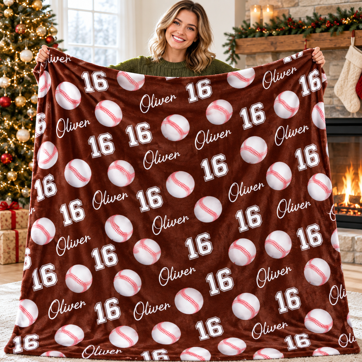 A woman displays a brown baseball pattern blanket personalized with the name Oliver and number 16.