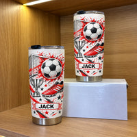 Two red soccer tumbler personalized custom name cups with red splatter graphics displayed on wooden shelves.