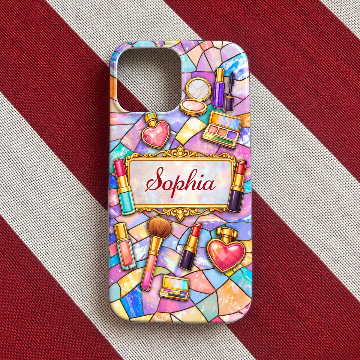Single personalized makeup phone case featuring stained glass mosaic pattern and name Sophia on red and white striped fabric.