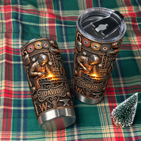 Two stainless steel travel tumblers with welder design resting on green and red plaid fabric.