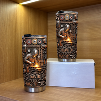 Two steampunk welder tumblers with custom name David on wooden shelf against wood background.