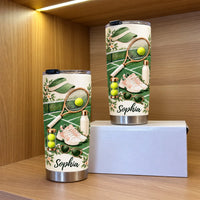 Two custom name tumblers shown on a wooden shelf next to a white presentation box.