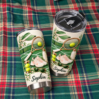 Two stainless steel tumblers with tennis court prints, rackets, sneakers, and the custom name Sophia on a plaid fabric.