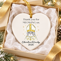 Heart-shaped personalized ceramic cat wedding gift ornament displayed inside an open gift box with gold ribbon.