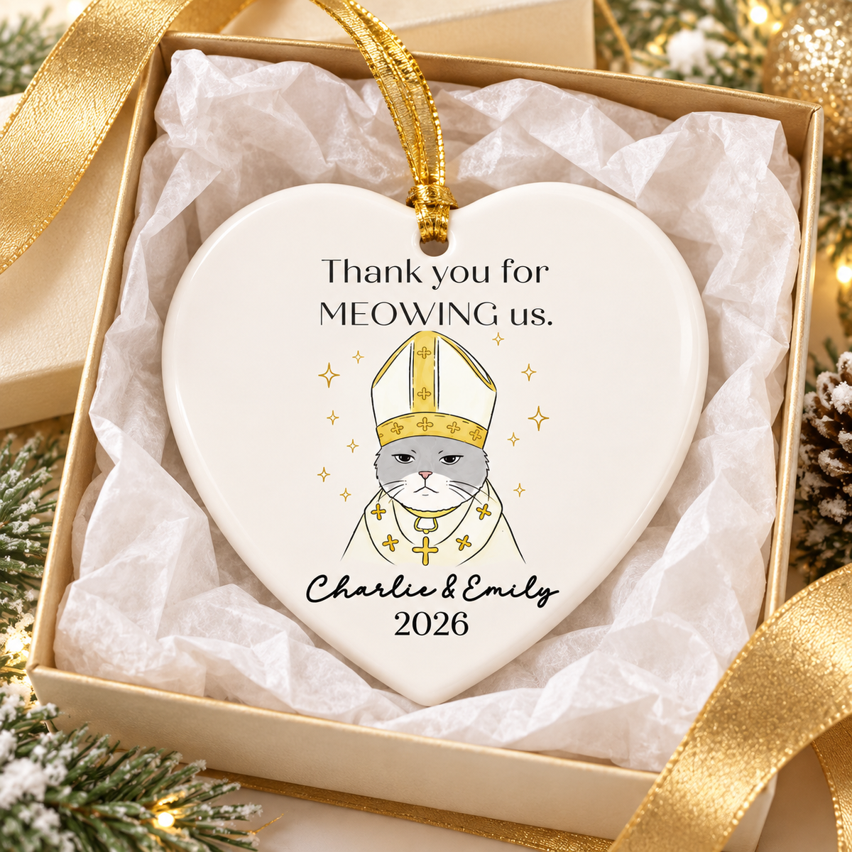 Heart-shaped personalized ceramic cat wedding gift ornament displayed inside an open gift box with gold ribbon.