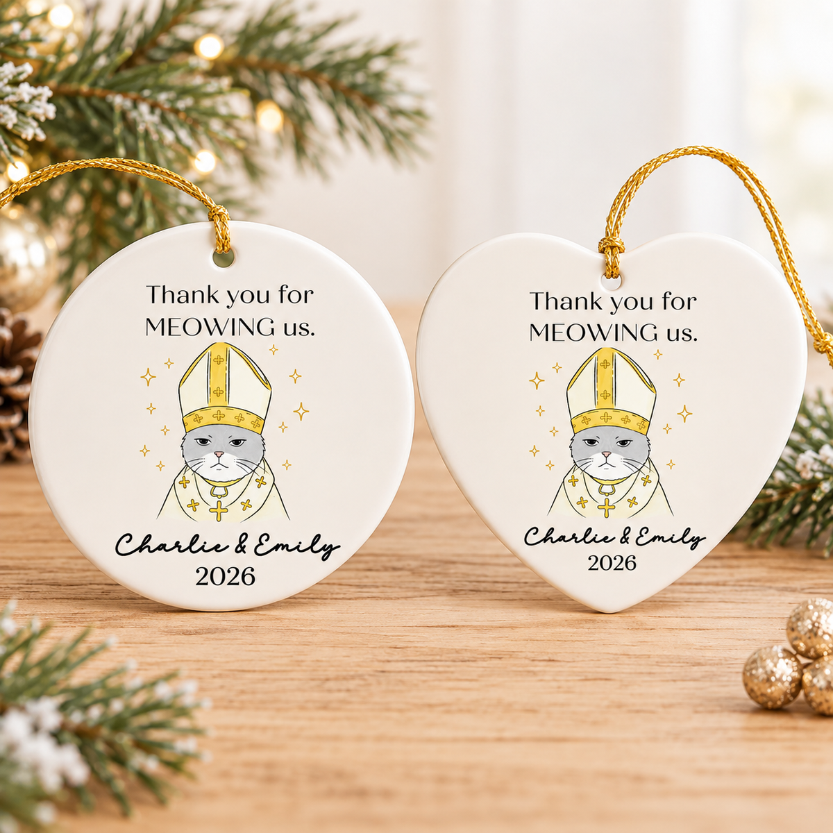 Round and heart-shaped personalized cat wedding gift ceramic ornaments displayed together on a wooden table.