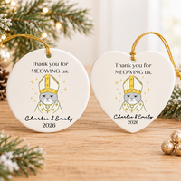 Round and heart-shaped personalized cat wedding gift ceramic ornaments displayed together on a wooden table.