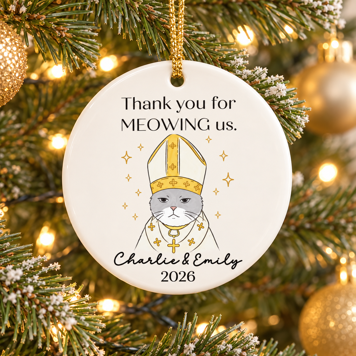 Personalized cat wedding gift round ceramic ornament hanging on a festive Christmas tree with gold cord.