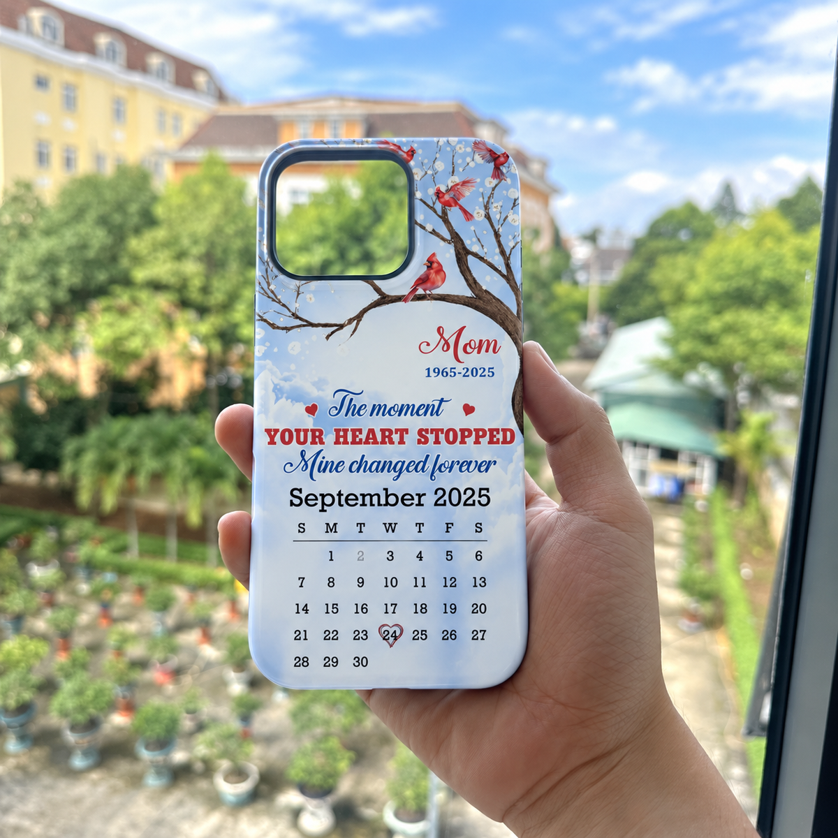 Customer in Austin, Texas wearing The Moment Your Heart Stopped Mine Changed Forever Memorial Cardinal Phone Case