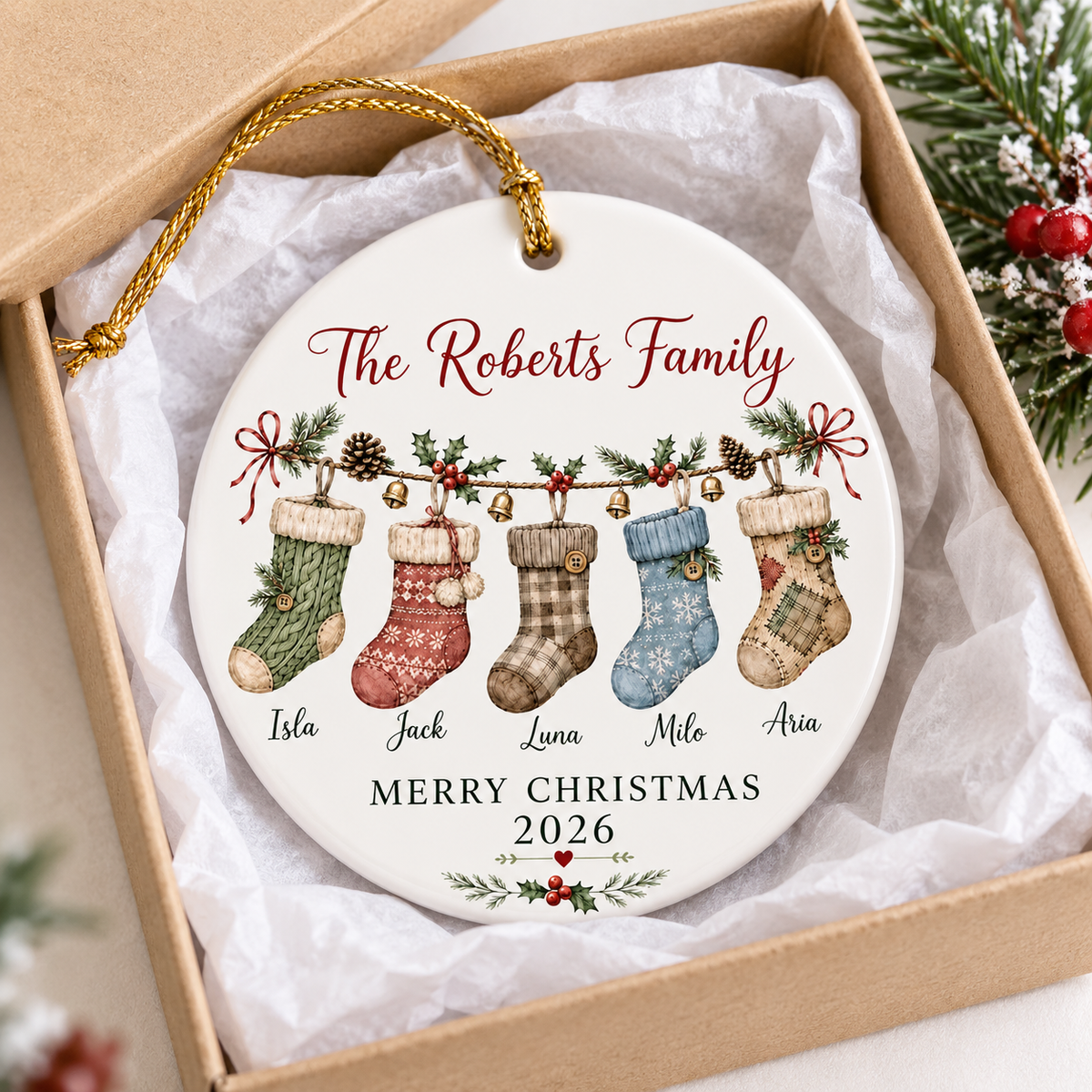 A Merry Christmas 2026 personalized family ornament presented inside an open gift box with tissue paper.