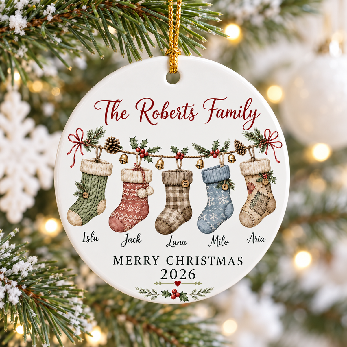 Merry Christmas 2026 personalized family ornament hanging on a snowy Christmas tree with warm lights.