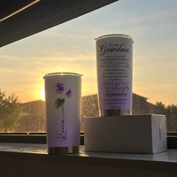 Personalized tumbler gift for grandmother and box displayed on a windowsill during a sunset.