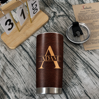 To My Wonderful Grandson tumbler next to a clear lid and wooden desk calendar on a rustic textured surface.