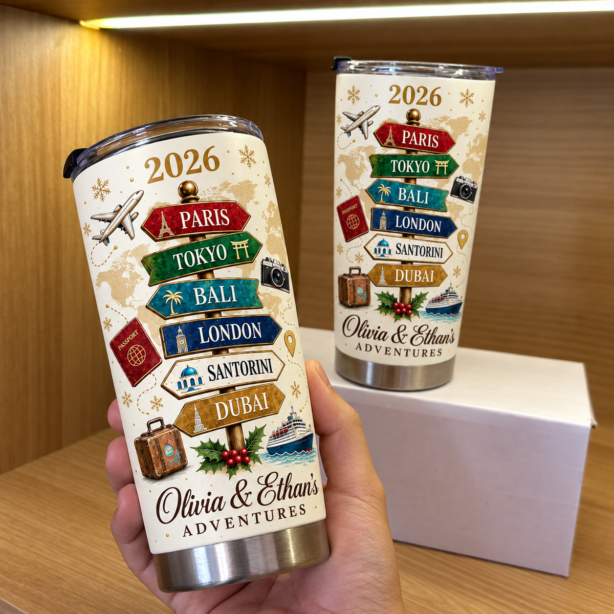 Hand holding a personalized travel bucket list signpost tumbler with a cream background, 2026 year, and couple names.