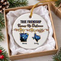 Personalized friendship ornament in a brown gift box lined with white tissue paper next to pine needles.